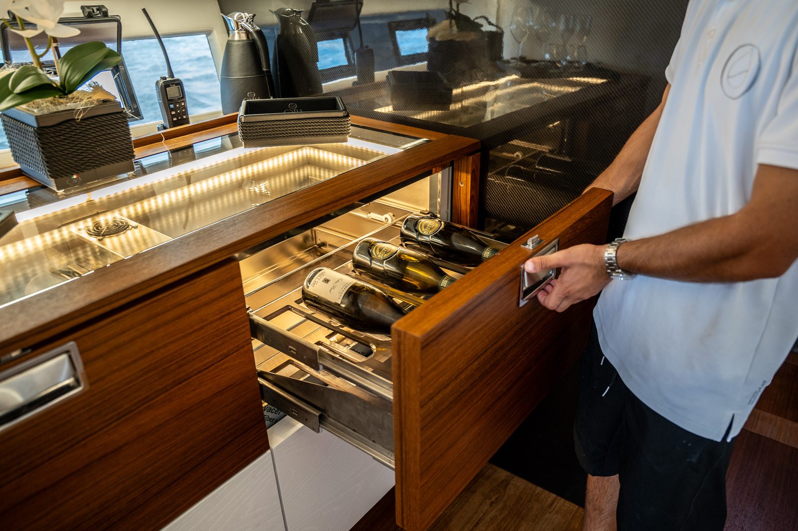 Il cassetto refrigerato in teak aperto, con le bottiglie in ghiaccio.